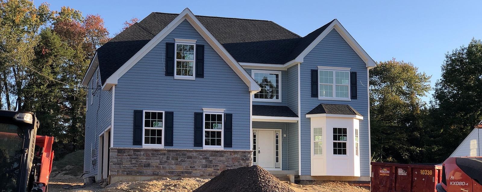 A newly finished two-storey house with equipment still on the lot